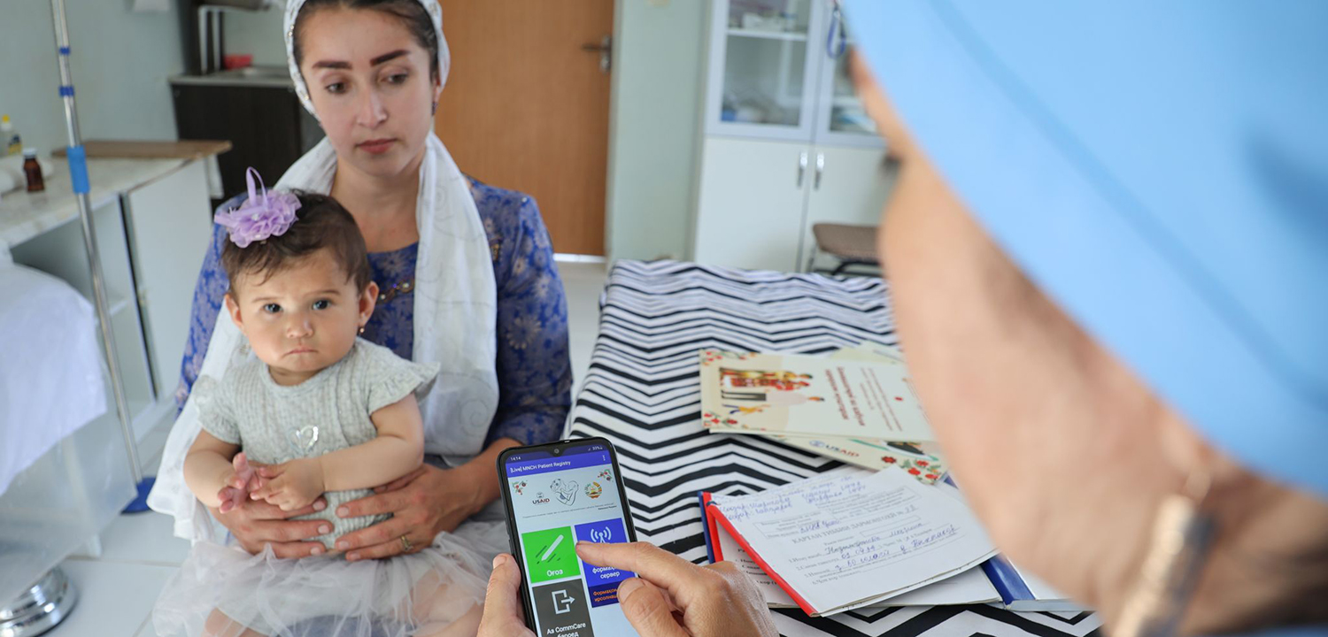 mother with baby talking to doctor