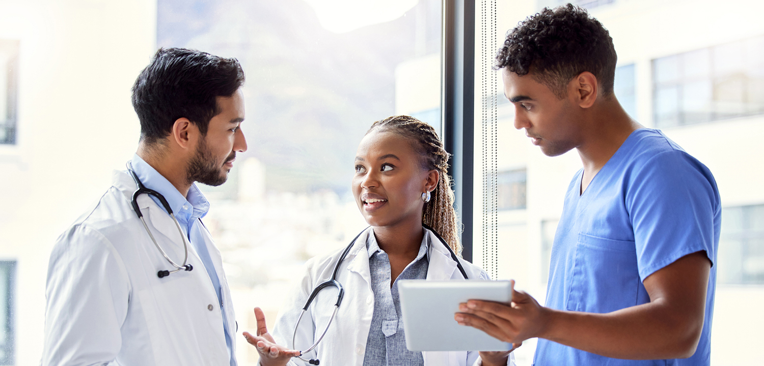 Shot of a group of doctors using a digital tablet at work