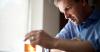 Man measuring weight of liquid in beaker