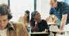 student sitting at desk with teacher