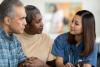 medical professional talking to older man and woman