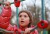 young girl on playground cargo net