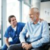 medical professional talking to patient in wheelchair