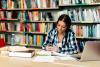 Female student using smart phone in library