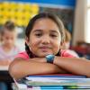 Hispanic school girl in classroom smiling