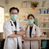 2 Asian Chinese doctors smiling with face mask